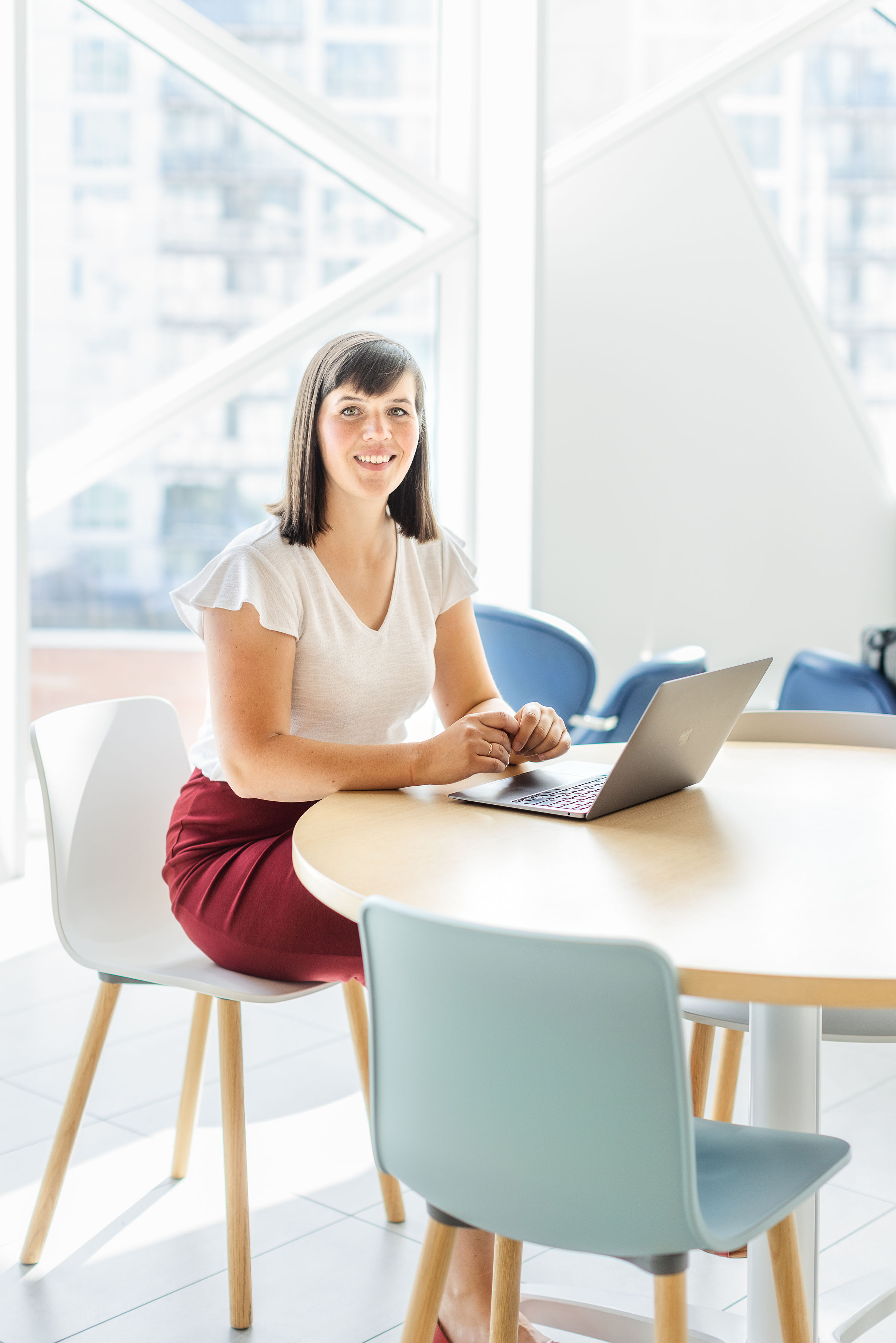 Nadia Zubko sitting at a desk with a laptop